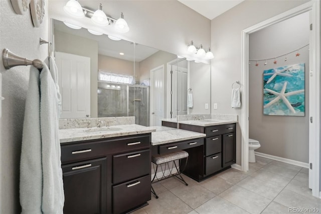 bathroom with a shower stall, tile patterned floors, two vanities, baseboards, and toilet