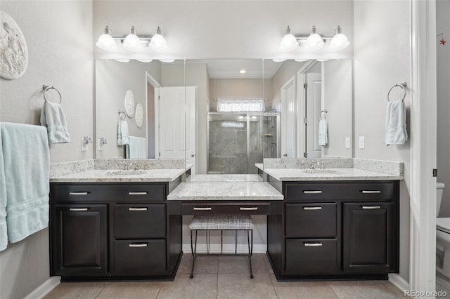 full bathroom with a stall shower, toilet, two vanities, and tile patterned floors