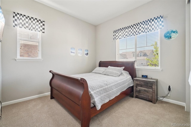carpeted bedroom featuring baseboards
