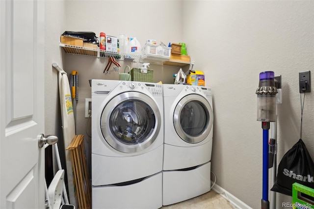 laundry area featuring washing machine and dryer and baseboards