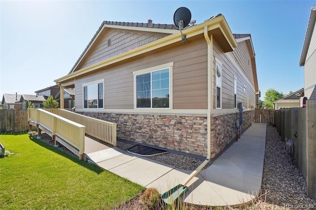 view of side of property with stone siding