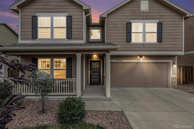 view of front of house with a garage and a porch