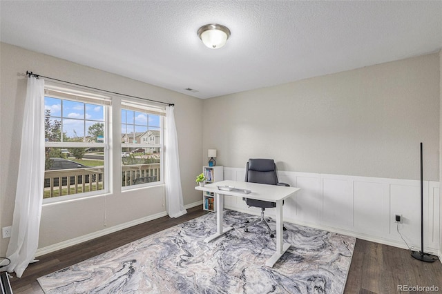 office space featuring dark hardwood / wood-style flooring and a textured ceiling