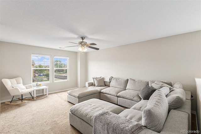 carpeted living room with ceiling fan