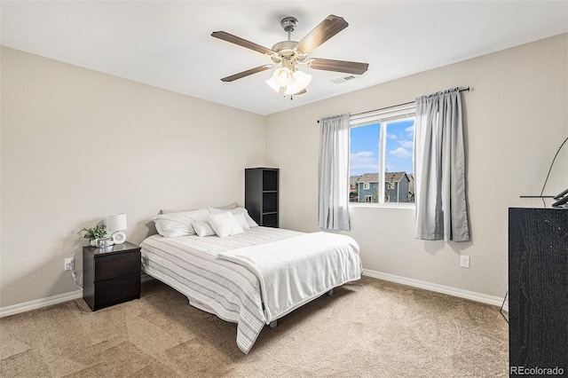 bedroom featuring light colored carpet and ceiling fan