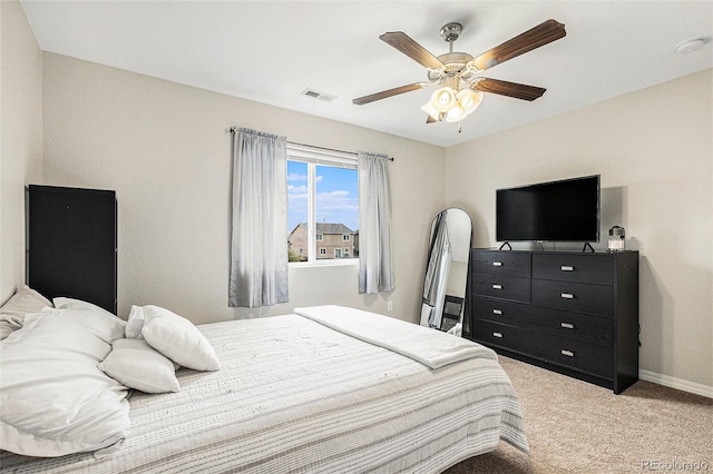 bedroom featuring light carpet and ceiling fan