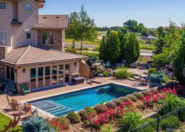 pool featuring a patio and fence