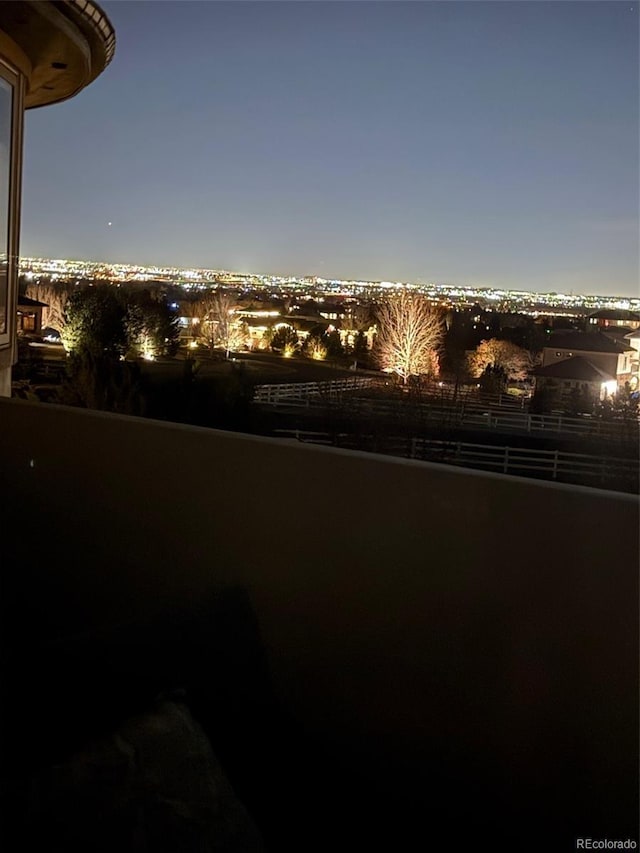 yard at night featuring fence