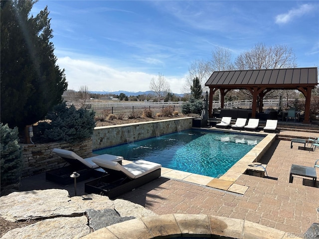 view of pool featuring a gazebo, a fenced in pool, fence, and a patio area