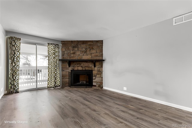 unfurnished living room with a fireplace and hardwood / wood-style floors