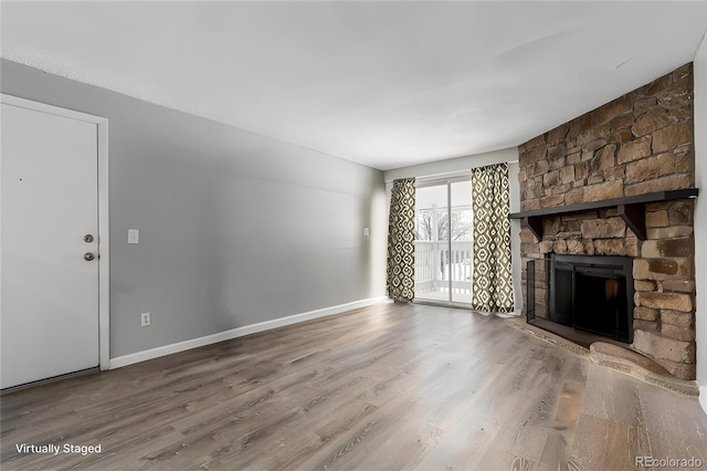 unfurnished living room featuring hardwood / wood-style flooring and a fireplace