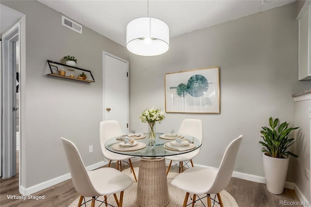 dining space featuring wood-type flooring