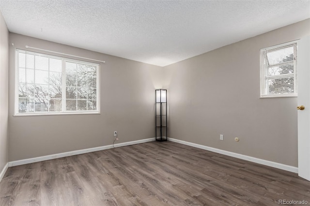 unfurnished room featuring hardwood / wood-style floors and a textured ceiling