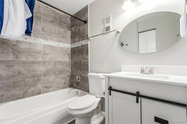 full bathroom with vanity, toilet, and tiled shower / bath combo