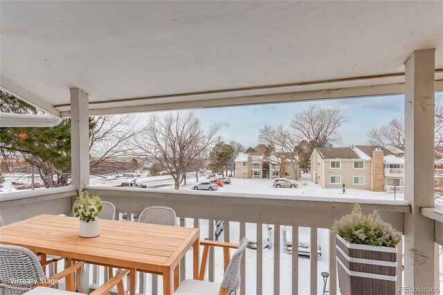 view of snow covered back of property