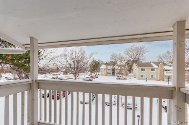 view of snow covered back of property