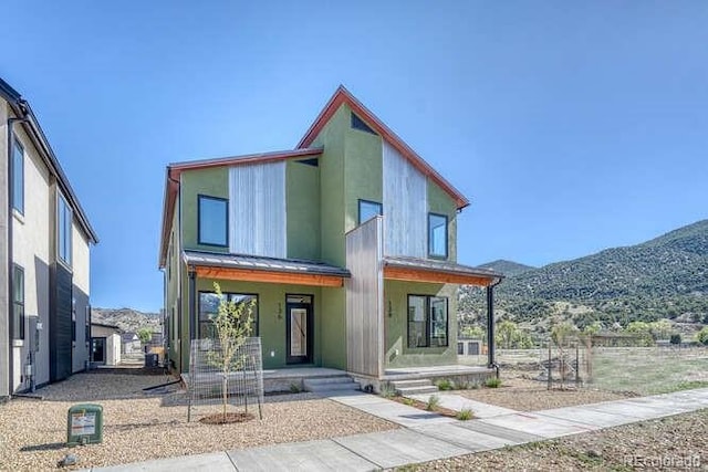 136 Chase St, Salida, CO 81201 - contemporary home featuring a porch, a mountain view, and stucco siding
