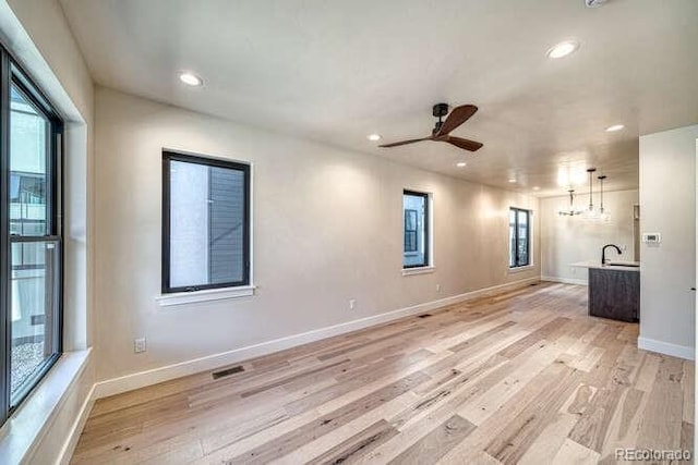 136 Chase St, Salida, CO 81201 - unfurnished living room with light wood-type flooring, ceiling fan, recessed lighting, and a chandelier