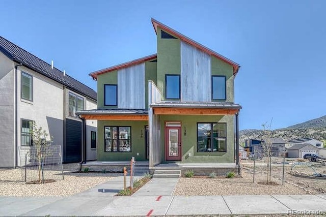 136 Chase St, Salida, CO 81201 - view of front of house featuring a porch, a standing seam roof, and a metal roof