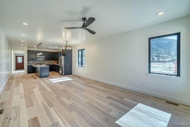 136 Chase St, Salida, CO 81201 - unfurnished living room featuring a ceiling fan, recessed lighting, a chandelier, and light wood-style flooring