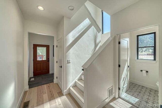 136 Chase St, Salida, CO 81201 - entryway featuring plenty of natural light, light wood finished floors, stairway, and recessed lighting