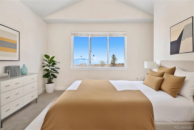 bedroom featuring lofted ceiling and light colored carpet