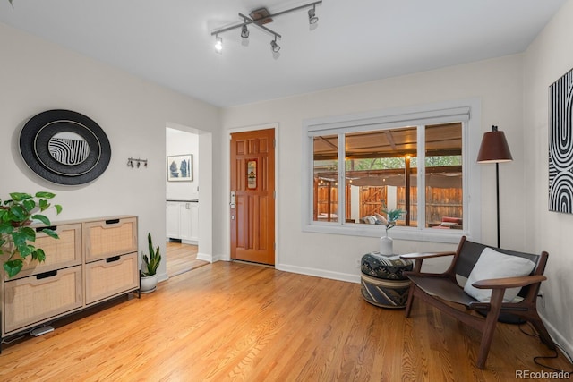 sitting room featuring light wood finished floors and baseboards
