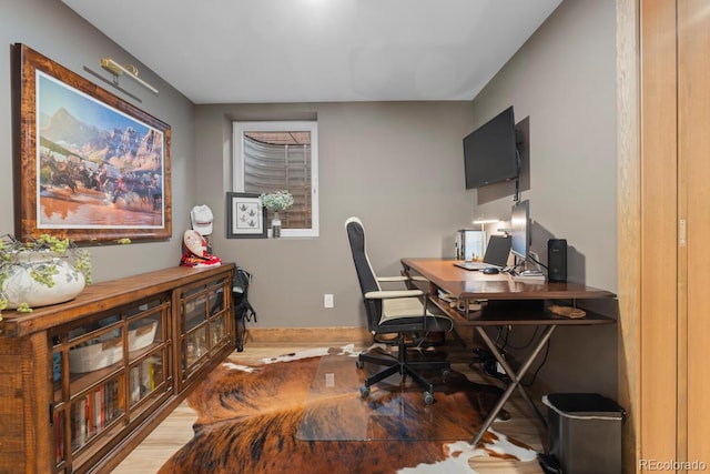 office space featuring wood finished floors and baseboards