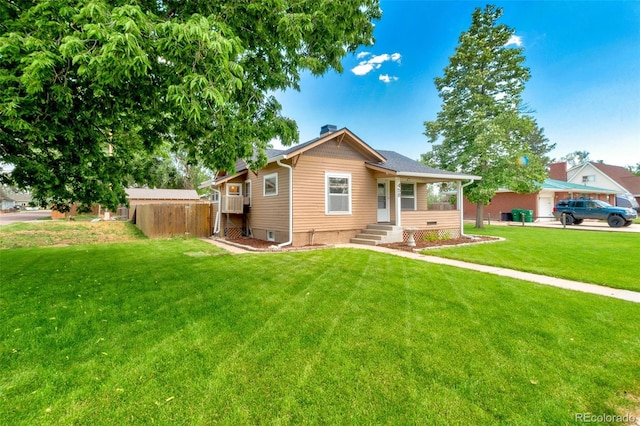 458 Cherry St, Hudson, CO 80642 - bungalow with a chimney, a front lawn, and covered porch