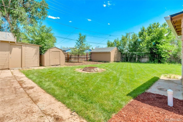 458 Cherry St, Hudson, CO 80642 - fenced backyard with a storage unit and a fire pit