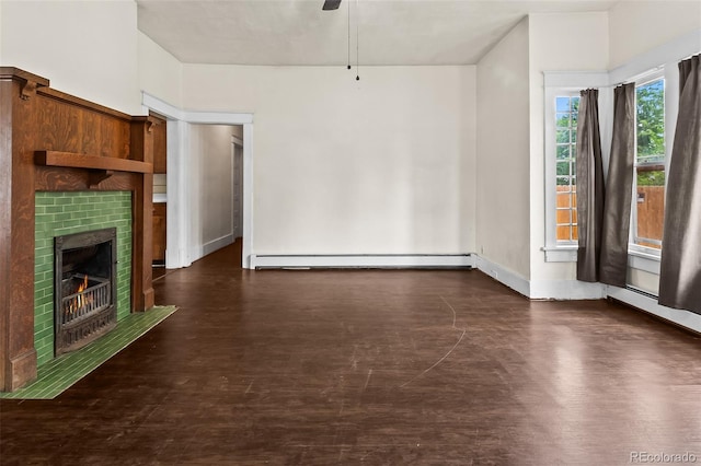 458 Cherry St, Hudson, CO 80642 - unfurnished living room featuring a baseboard heating unit, a ceiling fan, a fireplace, and wood finished floors