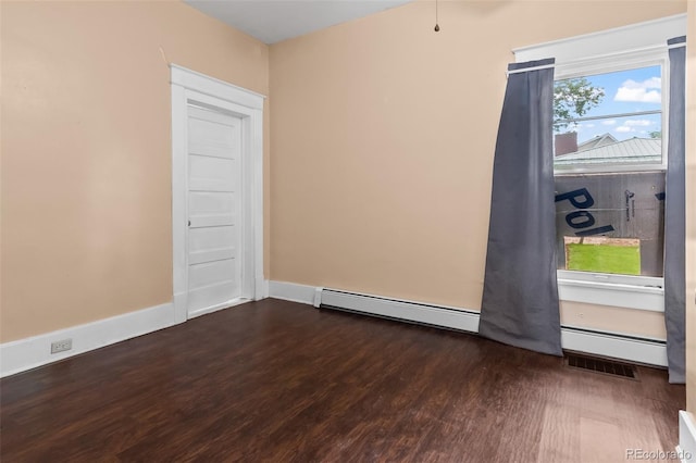458 Cherry St, Hudson, CO 80642 - spare room featuring a baseboard radiator and dark wood finished floors