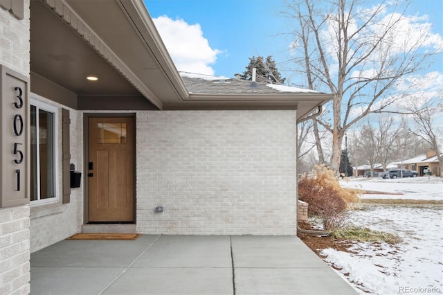 view of snow covered property entrance