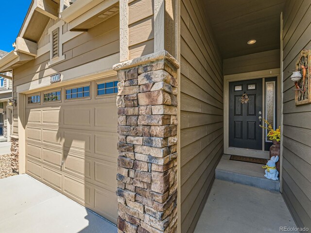 16658 Prospect Ln, Broomfield, CO 80023 - property entrance with concrete driveway and an attached garage