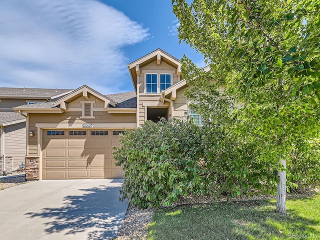 16658 Prospect Ln, Broomfield, CO 80023 - view of front of house with driveway, an attached garage, a shingled roof, and stone siding