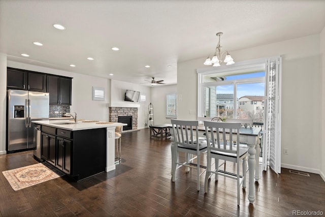 4391 Mcmurdo Ct, Castle Rock, CO 80108 - kitchen featuring appliances with stainless steel finishes, a ceiling fan, light countertops, recessed lighting, and a fireplace
