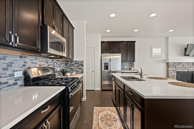 4391 Mcmurdo Ct, Castle Rock, CO 80108 - kitchen with stainless steel appliances, decorative backsplash, dark brown cabinetry, dark wood-type flooring, and recessed lighting
