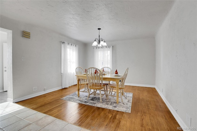 dining space featuring a chandelier and light hardwood / wood-style floors