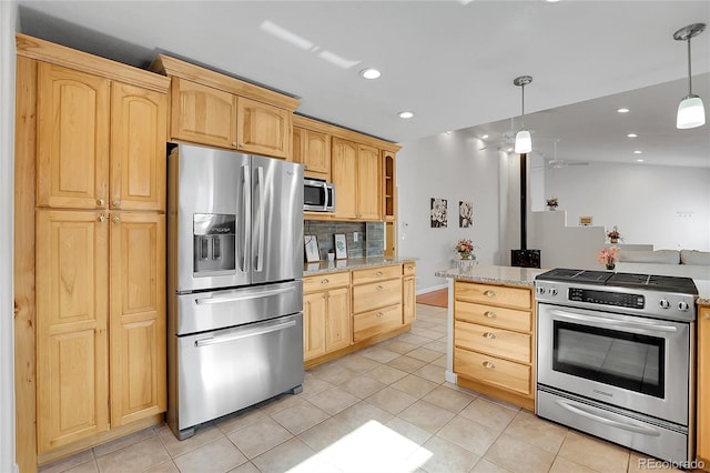 kitchen with light stone countertops, appliances with stainless steel finishes, light brown cabinetry, tasteful backsplash, and pendant lighting