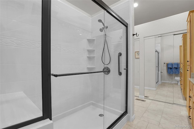 bathroom with tile floors, vanity, and walk in shower