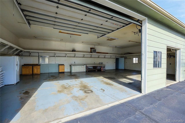 garage with white fridge with ice dispenser