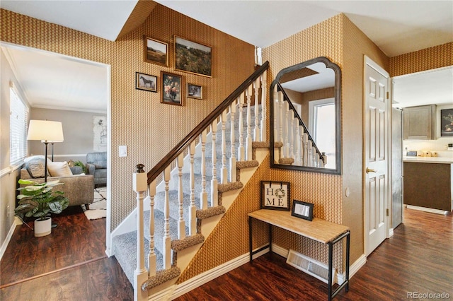 stairway with crown molding and hardwood / wood-style flooring