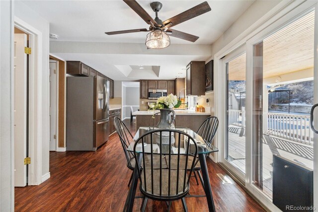 dining area with ceiling fan and dark hardwood / wood-style floors