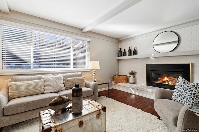 living room with a brick fireplace, beam ceiling, and dark hardwood / wood-style floors