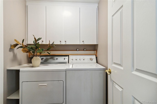 laundry area with cabinets and washer and clothes dryer