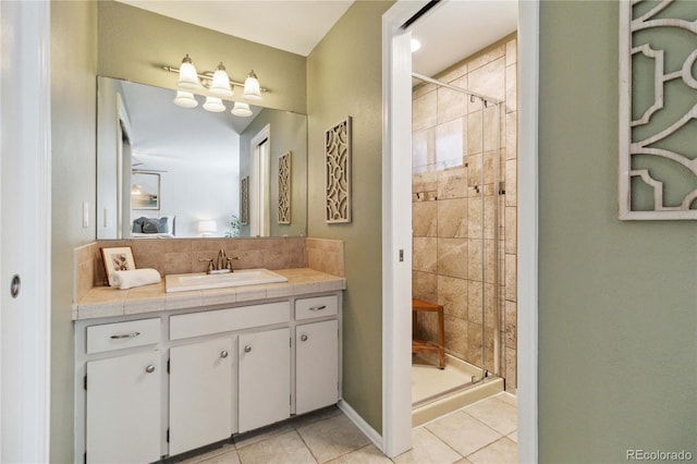 bathroom featuring tile patterned floors, vanity, and a shower with shower door