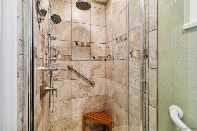 interior details with a shower with door