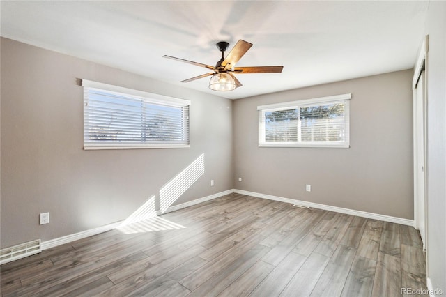 spare room with ceiling fan and hardwood / wood-style flooring