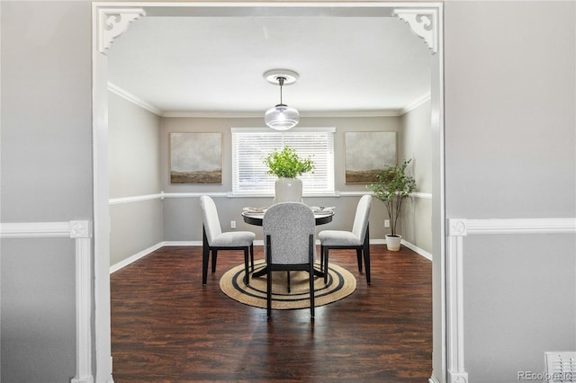 dining room featuring dark hardwood / wood-style floors and ornamental molding