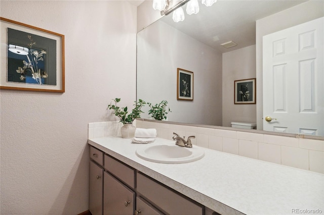 bathroom featuring toilet and vanity